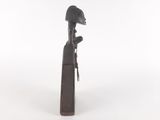 an image of a wooden statue of a woman with a hat on her head