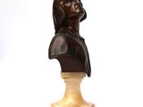 statue of a woman with a veil on her head on a marble base