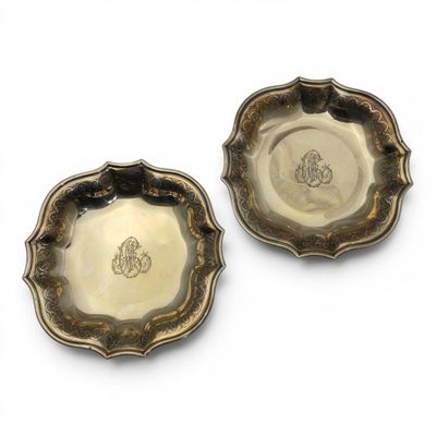 pair of silver plated dishes with monograms on them