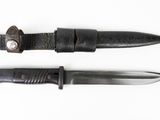 pair of knives on a white surface with a white background