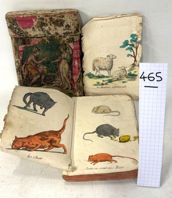 three old books with illustrations of cats and mice on them
