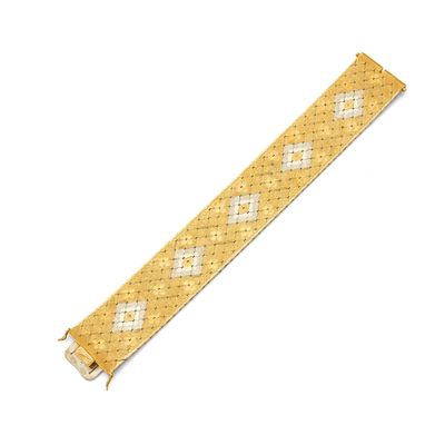 a close up of a gold bracelet with diamonds on it