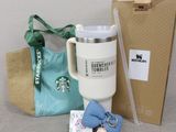a starbucks cup, a bag, and a keychain on a table