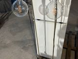 two lamps that are on a stand in a room