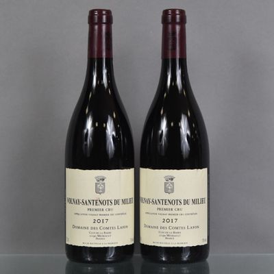 two bottles of wine sitting on top of a table next to each other