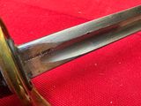 a close up of a knife on a red table