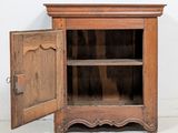 a wooden cabinet with a door open on the floor