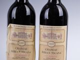 two bottles of wine sitting next to each other on top of a table