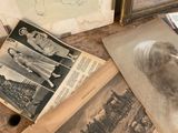 many old photos on the floor of this room