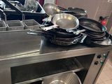 many pots and pans on the counter in the kitchen