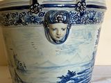 a blue and white container with a woman ' s face on it