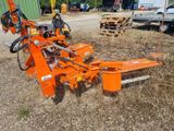 an orange machine that is sitting in the grass