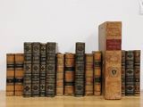 several old books are stacked on top of each other on a table