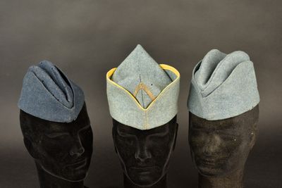 three hats are lined up on top of a mannequin head