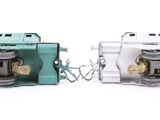 two green and white electrical switches on a white surface