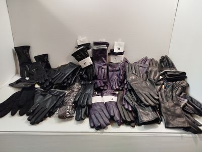 several pairs of black leather gloves on display in a display case