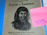 a book on a table with a pink sticky note on it