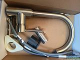 a box with a hose, a hose, and other items in it