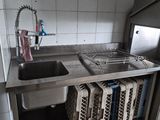 une cuisine équipée d'un évier, d'une cuisinière et d'un réfrigérateur