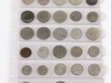 an assortment of coins in a plastic case on a white surface