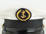 a white hat with a gold emblem on it