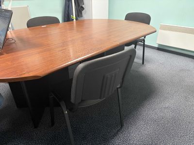 a large table with a laptop on it in a room