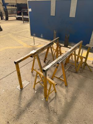 several pieces of wood sit on top of a table in a warehouse