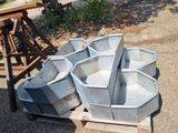 many buckets sitting on a pallet on the ground