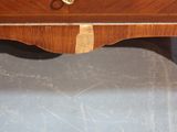 a small wooden table with a drawer on top of it