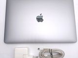 an apple laptop with a charger attached to it