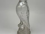 an image of a glass figurine of a bird on a pedestal