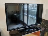 a flat screen tv sitting on a stand in a living room