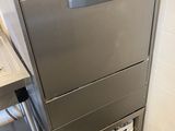 stainless steel dishwasher in a commercial kitchen next to a counter