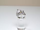 a ring that is sitting on top of a clear glass