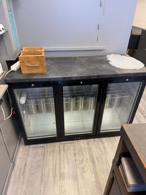 a counter with two glass doors in the middle of a kitchen