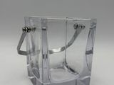 a clear glass cup with a handle on a table