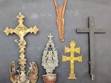 several crosses and other religious items are displayed on a black surface