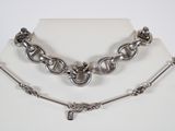 an image of a silver necklace and bracelet set on a mannequin