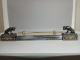 a statue of two lions on a table with a towel rack