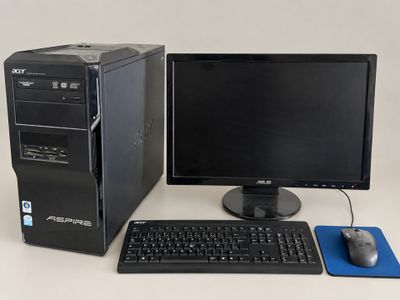 a desktop computer sitting next to a keyboard and mouse