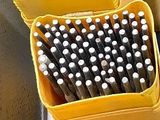 a lot of pencils that are sitting in a yellow container