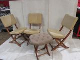 three chairs and a stool are sitting on a rug in front of a white backdrop