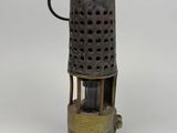 an old fashioned metal oil burner on a white background