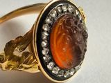 an image of a close up of a ring with a face on it