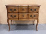 a wooden chest of drawers with brass handles on it