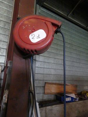 a red hose attached to the side of a building