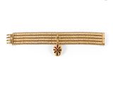 a close up of a gold bracelet on a white background