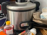 a crock pot sitting on a counter next to other food items