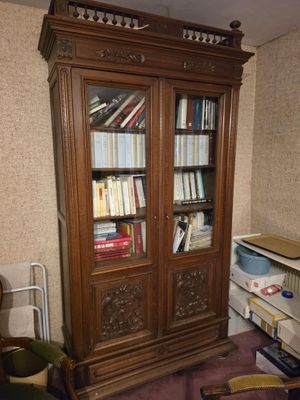 a book case with many books on it in a room