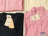 three shirts with a price tag on them sitting next to each other